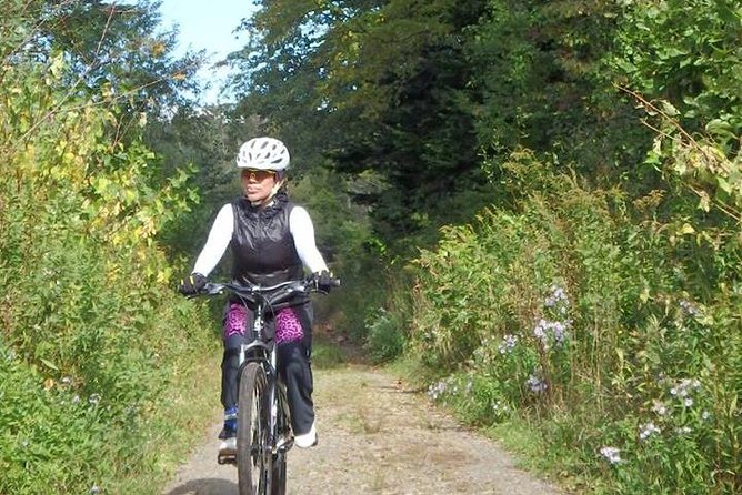 Nopporo Forest Mountain Bike Tour from Sapporo, presenting a retro Cycle cap - Passing training tracks and the Centennial Memorial Tower